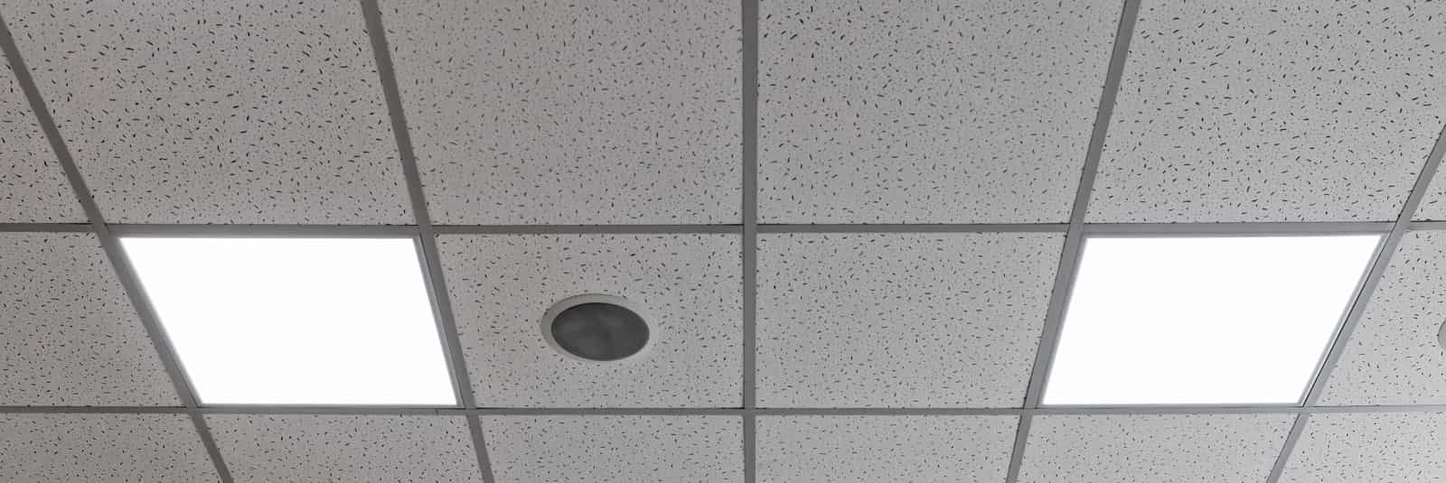 Suspended ceilings with an exposed grid, textured tiles and inset lighting