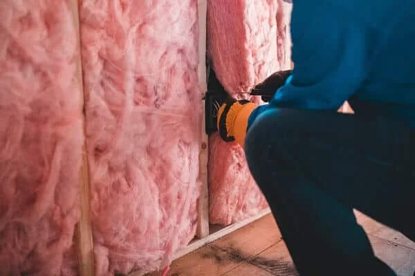 Man working on home insulation